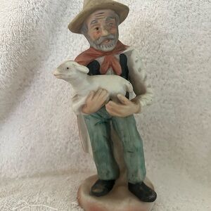 Man Holding Lamb Figure